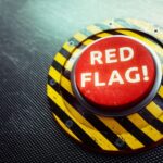 Red button with the words "Red Flag" written on it