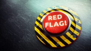 Red button with the words "Red Flag" written on it